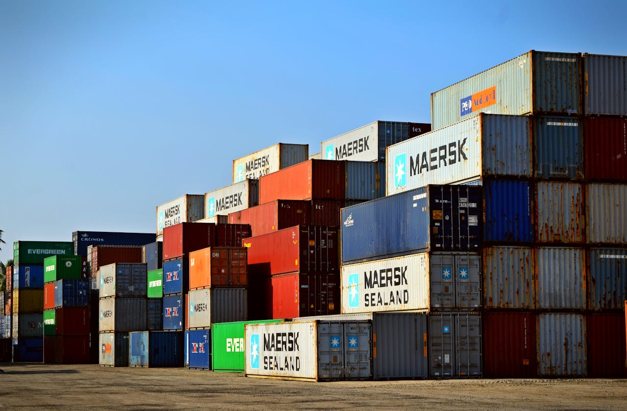 team-03 Colorful stacked shipping containers at a port exemplify global logistics.